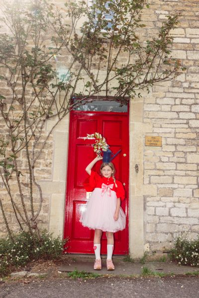 Flossy porte une robe Christina Rohde, un nœud Bebe Organic, des chaussettes Zara et des baskets Young Soles. - Doolittle